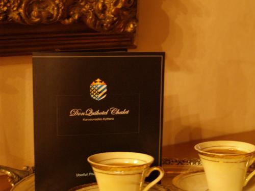 two cups of coffee sitting on a table at DonQuihotel Chalet in Karvounádhes