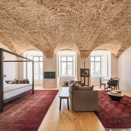 a living room with a couch and a table at The Visionaire Apartments in Lisbon