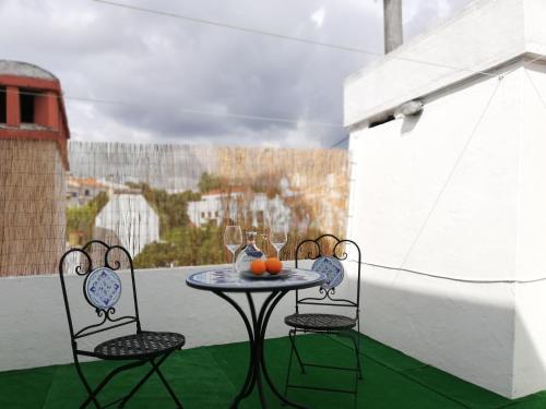 a small table and two chairs on a balcony at Arronches Villa in Arronches