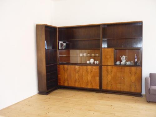a living room with a wooden book shelf at Zámek Dobrohoř in Dobrohoř