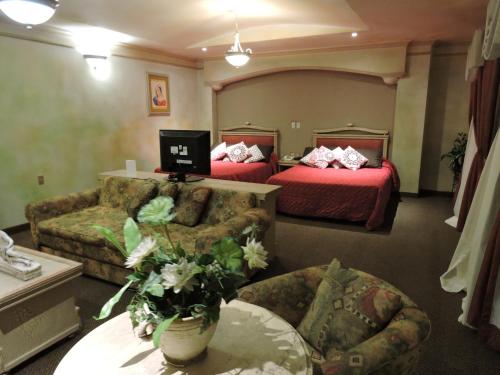 Postel nebo postele na pokoji v ubytování Hotel Quinta Cesar