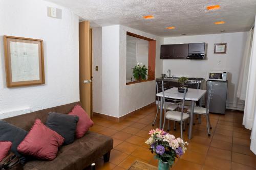 a living room with a couch and a table and a kitchen at Suite 4A, Terraza, Garden House, Welcome to San Angel in Mexico City