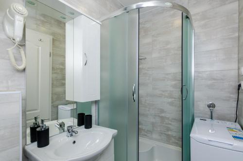 a bathroom with a sink and a glass shower at Apartments A&M in Dubrovnik
