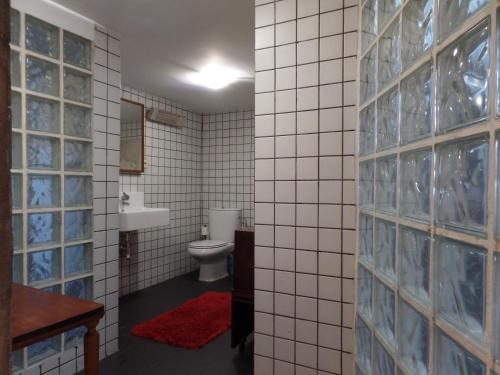 a bathroom with a toilet and a sink at Ponto de Vista - Coimbra in Coimbra