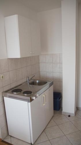 a kitchen with a sink and a counter top at Apartmani Šipić , Bilo - Primošten in Primošten