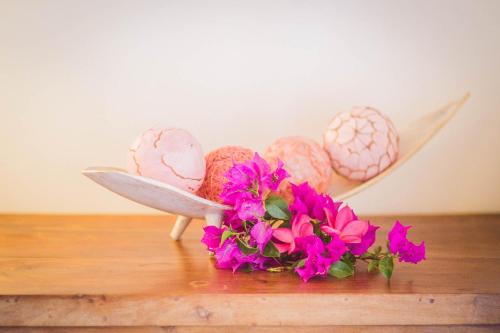 a bunch of easter eggs on a table with flowers at Carre Royal in Deshaies
