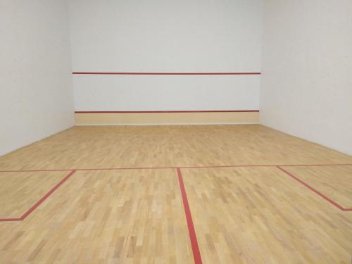 an empty room with a basketball court and a wooden floor at Atlantis Residence Melaka in Melaka