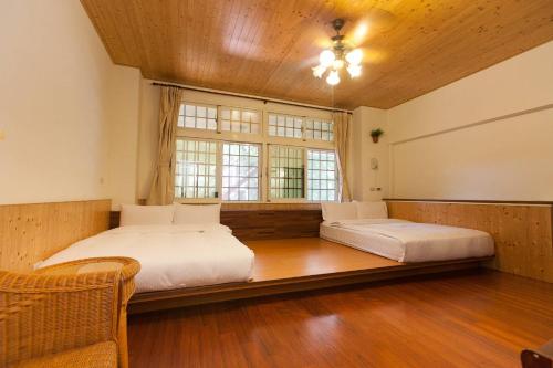 a large bedroom with two beds and a window at Locasu in Datong