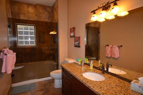 a bathroom with a sink and a shower and a toilet at Bella Luna Bed and Breakfast in West Kelowna