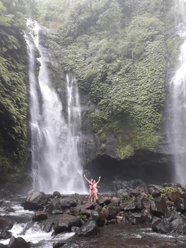 a person standing in front of a waterfall at Sugi Gede Homestay in Singaraja