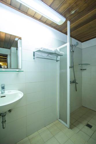 a bathroom with a shower and a sink at Schweizer Hotel in Cebu City