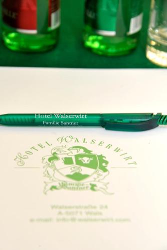 a green pen sitting on top of a white envelope at Hotel Walserwirt in Wals