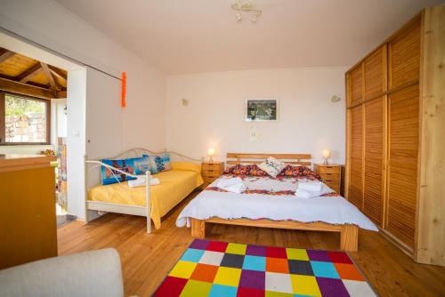 a bedroom with a king sized bed and a couch at Poseydon Beach Bungalow in Mlini