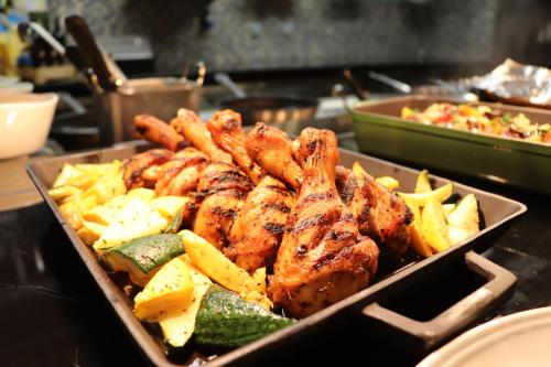 a tray of food with shrimp and vegetables on a counter at Pearl Rotana Capital Centre in Abu Dhabi