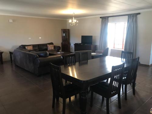 a living room with a table and a couch at Windmill Farm in Bergville
