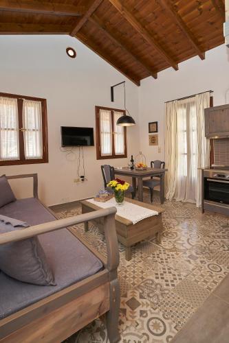 a living room with a couch and a table at Kaminos Boutique Hotel in Symi