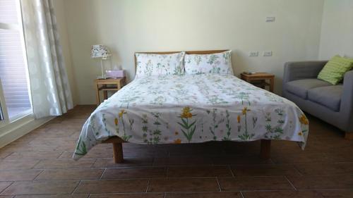 a bedroom with a bed and a couch at Taroko Xincheng Old Street in Xincheng