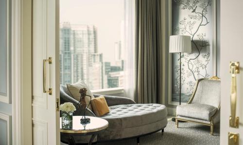 a living room with a couch and a window at Four Seasons Hotel Jakarta in Jakarta