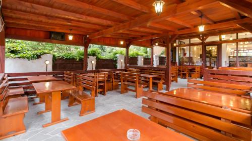 an empty restaurant with wooden tables and benches at Casa Luca in Vama Veche