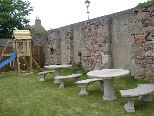 a group of picnic tables and a playground at Belgrave Arms Hotel in Helmsdale