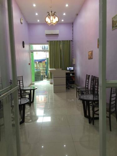 a dining room with tables and chairs and purple walls at Meaco Royal Hotel - Lipa in Lipa