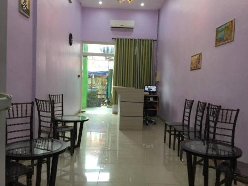a room with tables and chairs and purple walls at Meaco Royal Hotel - Lipa in Lipa