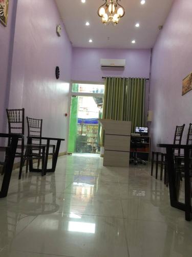 a dining room with chairs and a table and a chandelier at Meaco Royal Hotel - Lipa in Lipa