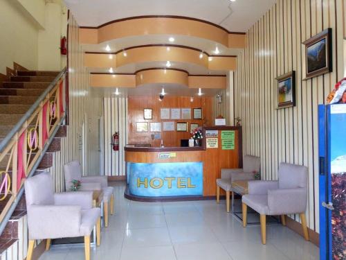 a hotel lobby with chairs and a hotel counter at Asia Novo Boutique Hotel - Midsayap in Midsayap