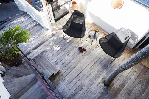 an overhead view of a deck with chairs and a table at 28 Degrees Byron Bay - Adults Only in Byron Bay