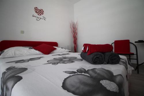 a bedroom with a bed with a black and white blanket at Private Accommodation Carevic in Dubrovnik