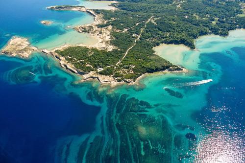 an aerial view of an island in the water at San Marino Resort in Lopar