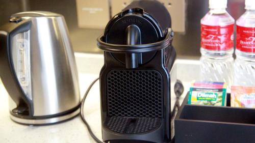 a black coffee maker sitting on top of a counter at Fraser Suites Dalian in Dalian