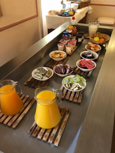 a buffet line with food and pitchers of orange juice at Belgrave Arms Hotel in Helmsdale