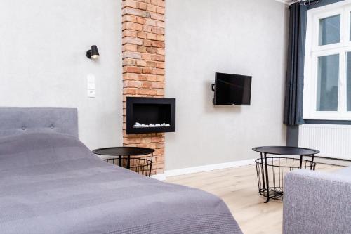 Televízia a/alebo spoločenská miestnosť v ubytovaní Apartament K2 Prosta 17
