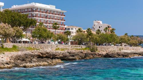 a view of a river with buildings in the background at Talayot - Adults Only in Cala Millor