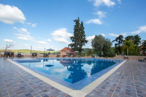 a large swimming pool with blue water in a resort at Hotel Dar Eddaya in Khemisset