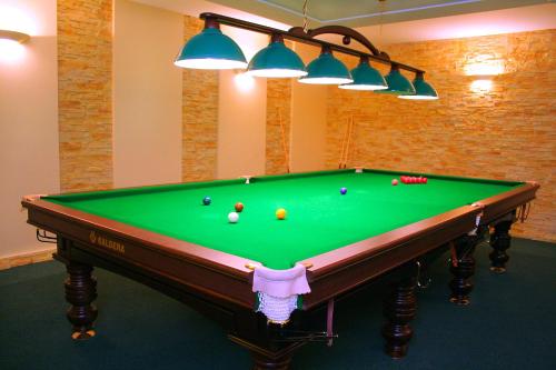 a pool table with balls on it in a room at Olimpija Hotel & SPA in Daugavpils