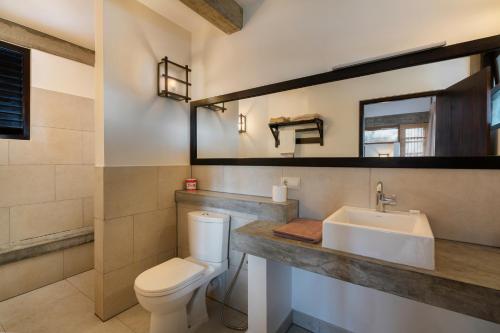 a bathroom with a toilet and a sink at Seven Turtles in Tangalle