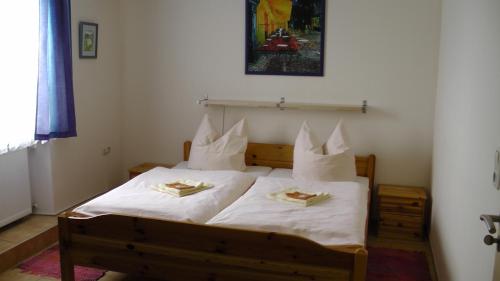 a bedroom with a bed with two plates of food on it at Assos Hotel in Asbach-Bäumenheim