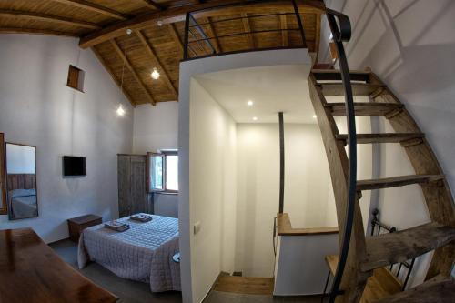 a room with a bed and a spiral staircase at PATRICIA BED&BREAKFAST in Patrica