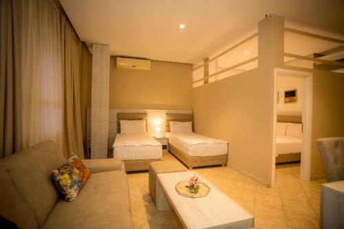 a living room with two beds and a couch at Hotel Valz in Velipojë
