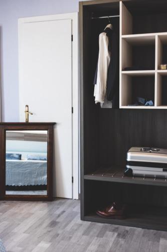 a bedroom with a closet with a bed and a door at Hotel Il Giardino in Siena