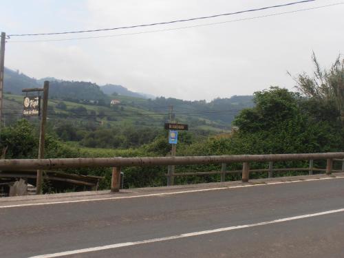 a road with a fence on the side of the road at Casa Rural Casa Pipo in Colunga
