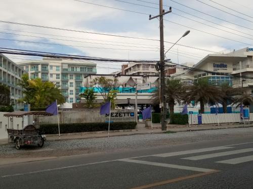 a street with purple flags on the side of the road at Grandblue Condominium 708 in Ban Nam Lai Ta Tum