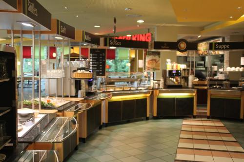 a fast food restaurant with a food counter at Autobahn Motel Siegerland Ost in Siegen