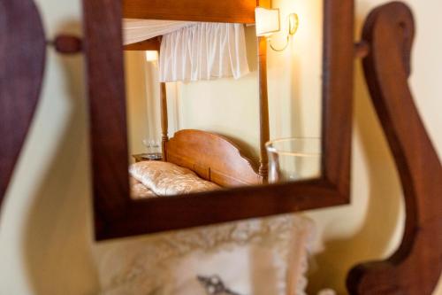 a mirror with a chair in a room at Agriturismo Selvella in Radicofani
