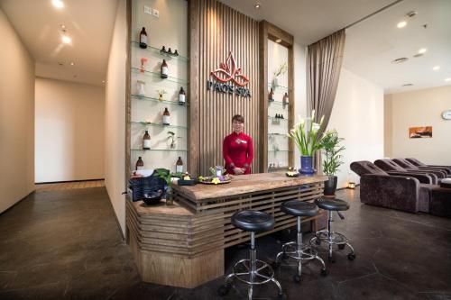 a woman standing behind a bar in a salon at Pao's Sapa Leisure Hotel in Sa Pa
