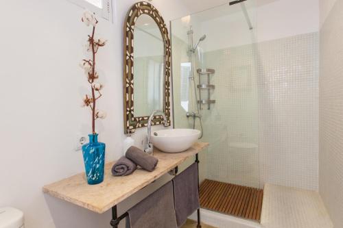 a bathroom with a sink and a mirror and a shower at Marina in Colonia Sant Jordi