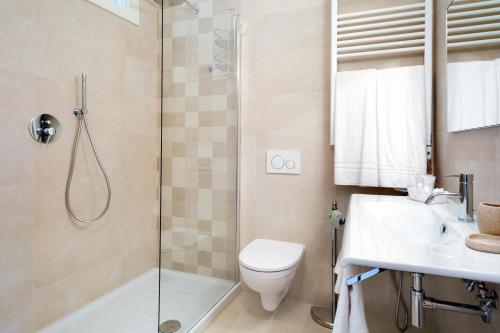 a bathroom with a shower and a toilet and a sink at Tenuta Lamborghini Golf & Resort in Panicale