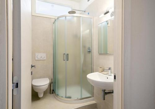 a bathroom with a shower and a toilet and a sink at Tenuta Lamborghini Golf & Resort in Panicale